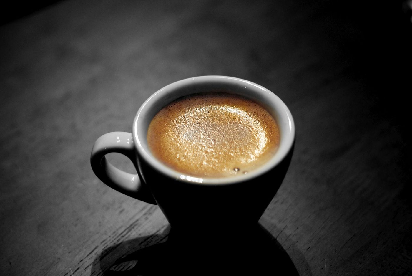 A cup of espresso on a dark table