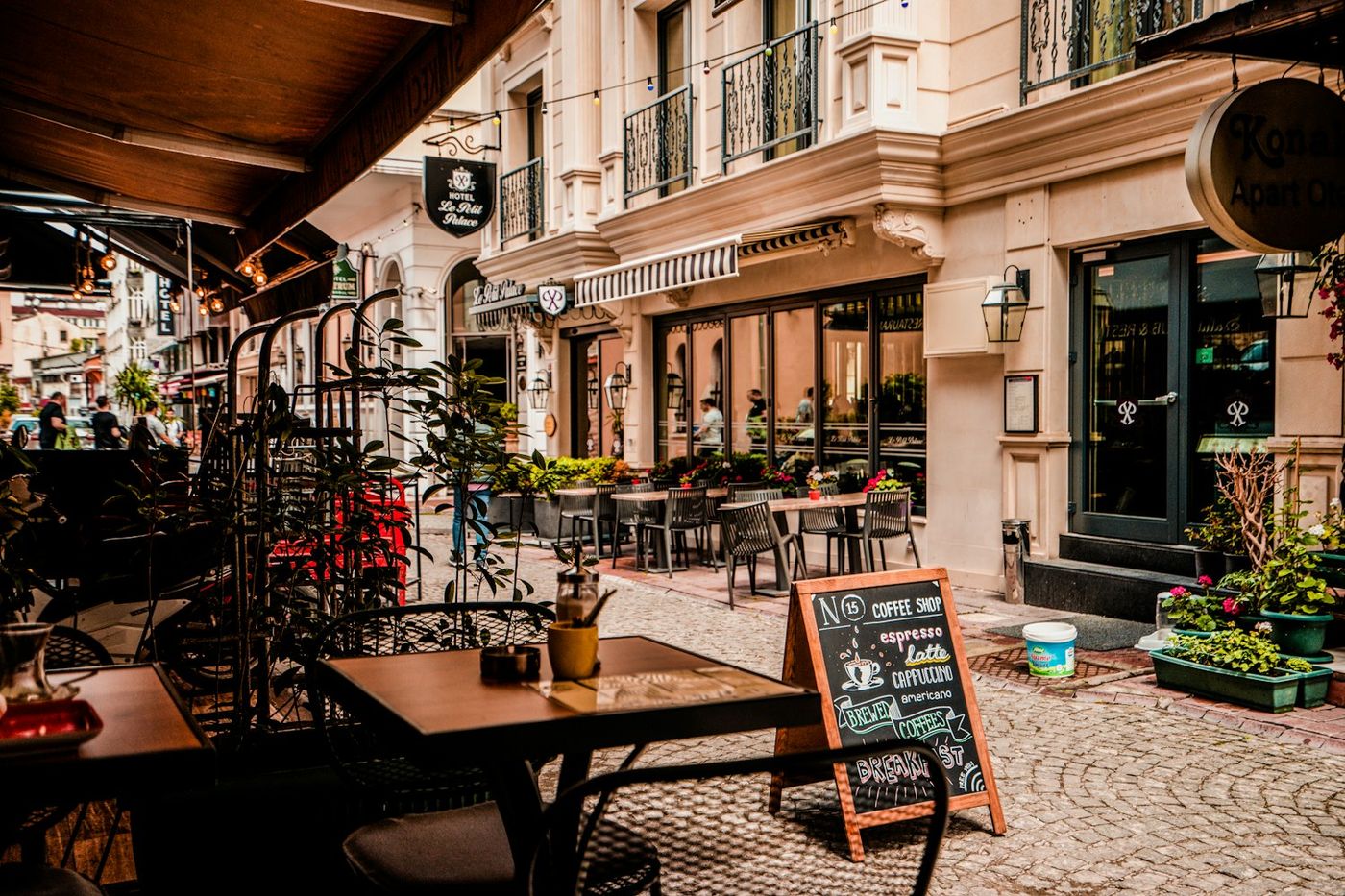 A cafe on a street corner with an A-frame board